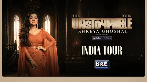 Shreya Ghoshal in a rust draped gown in a grand hall, beside the title of her Unstoppable India tour